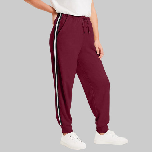 Merlot French terry jogger with side stripes, rib cuffs, and drawstring waist displayed on a clean studio background.