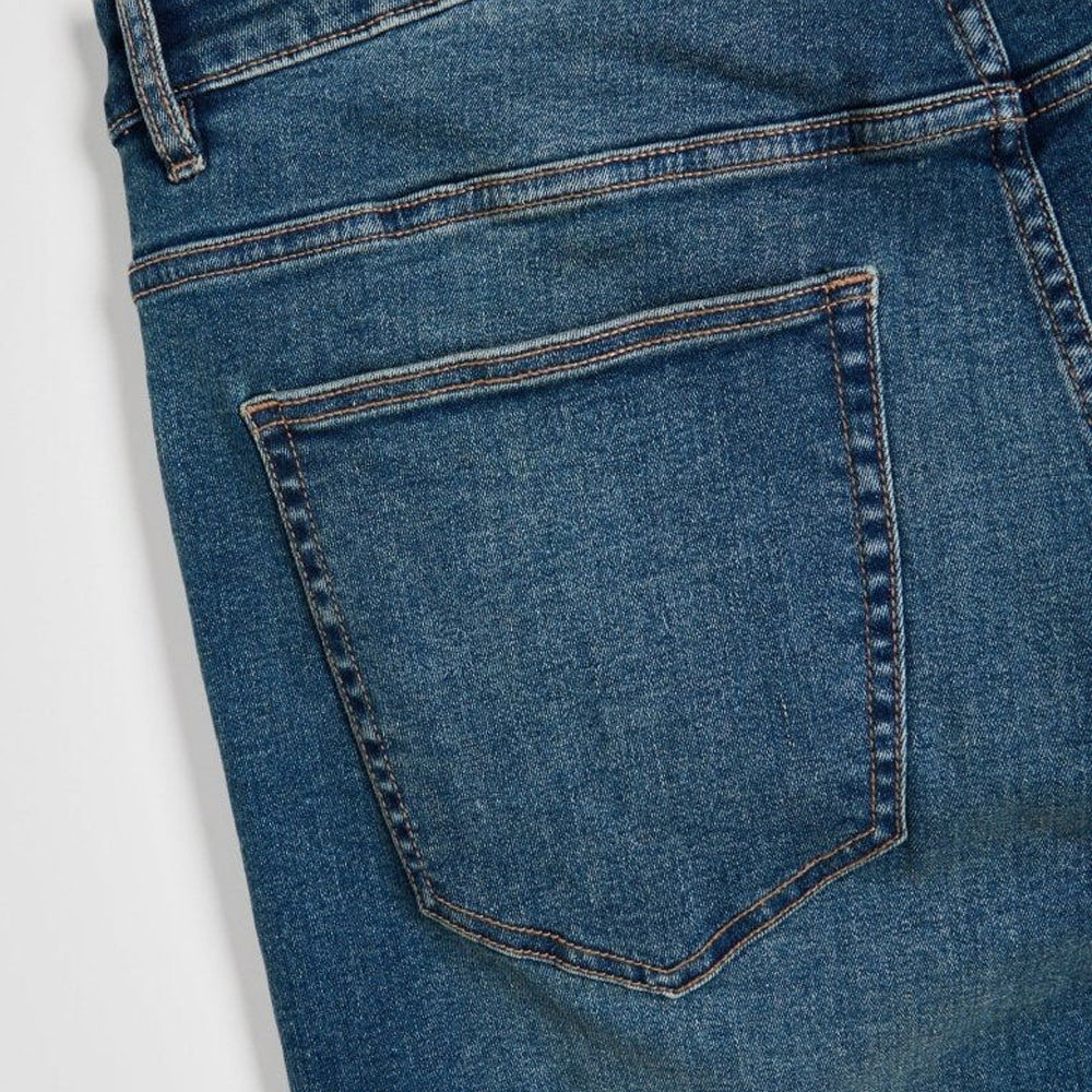 Men’s mid blue stretch slim fit denim jeans with fitted legs and clean wash, front studio view