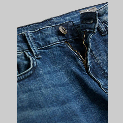 Flat-lay photo of Mid Wash Slim Straight Jeans in medium blue denim, subtle fading on thighs, classic five-pocket design, button-zip closure, front view.