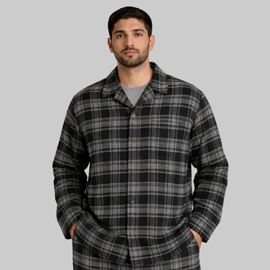 Pakistani male model wearing black and grey plaid flannel night shirt in 2XL size, front view on white background.