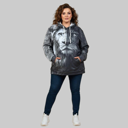 Plus-size male and female models wearing black “Midnight Strength” graphic hoodies with front print, styled in a cozy modern studio setup.