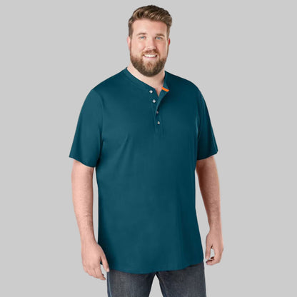 Plus-size Pakistani male model wearing midnight teal short-sleeve Henley shirt with 4-button placket on a studio background, relaxed fit.