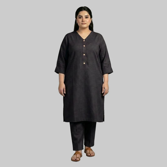Woman wearing a black kurta with pants on a gray background