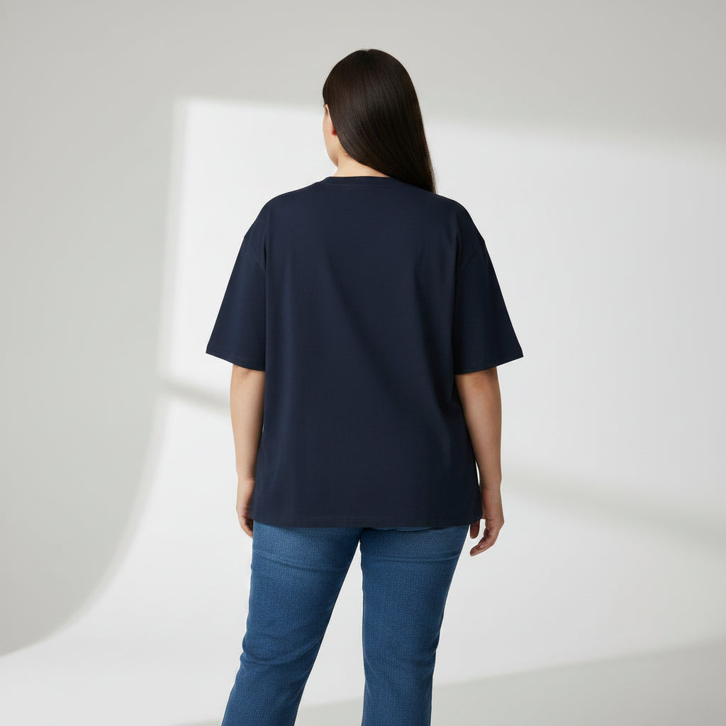 Person wearing a navy blue t-shirt and blue jeans on a white background