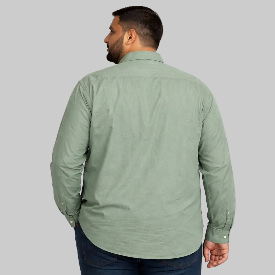Mint green plus size casual shirt worn by a Pakistani male model in size 2XL, featuring a relaxed fit, long sleeves, button-down front, and soft breathable fabric, photographed in a studio with a clean light background.