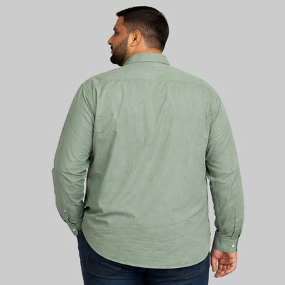 Mint green plus size casual shirt worn by a Pakistani male model in size 2XL, featuring a relaxed fit, long sleeves, button-down front, and soft breathable fabric, photographed in a studio with a clean light background.
