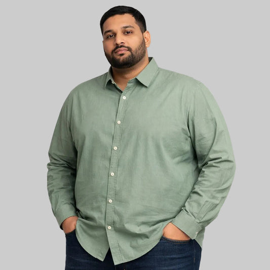 Mint green plus size casual shirt worn by a Pakistani male model in size 2XL, featuring a relaxed fit, long sleeves, button-down front, and soft breathable fabric, photographed in a studio with a clean light background.
