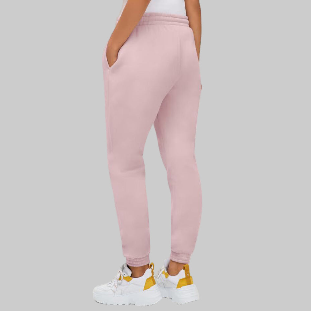 Plus-size woman wearing Misty Rose fleece jogger sweatpants with drawstring waist and elastic cuffs, styled with side pockets.