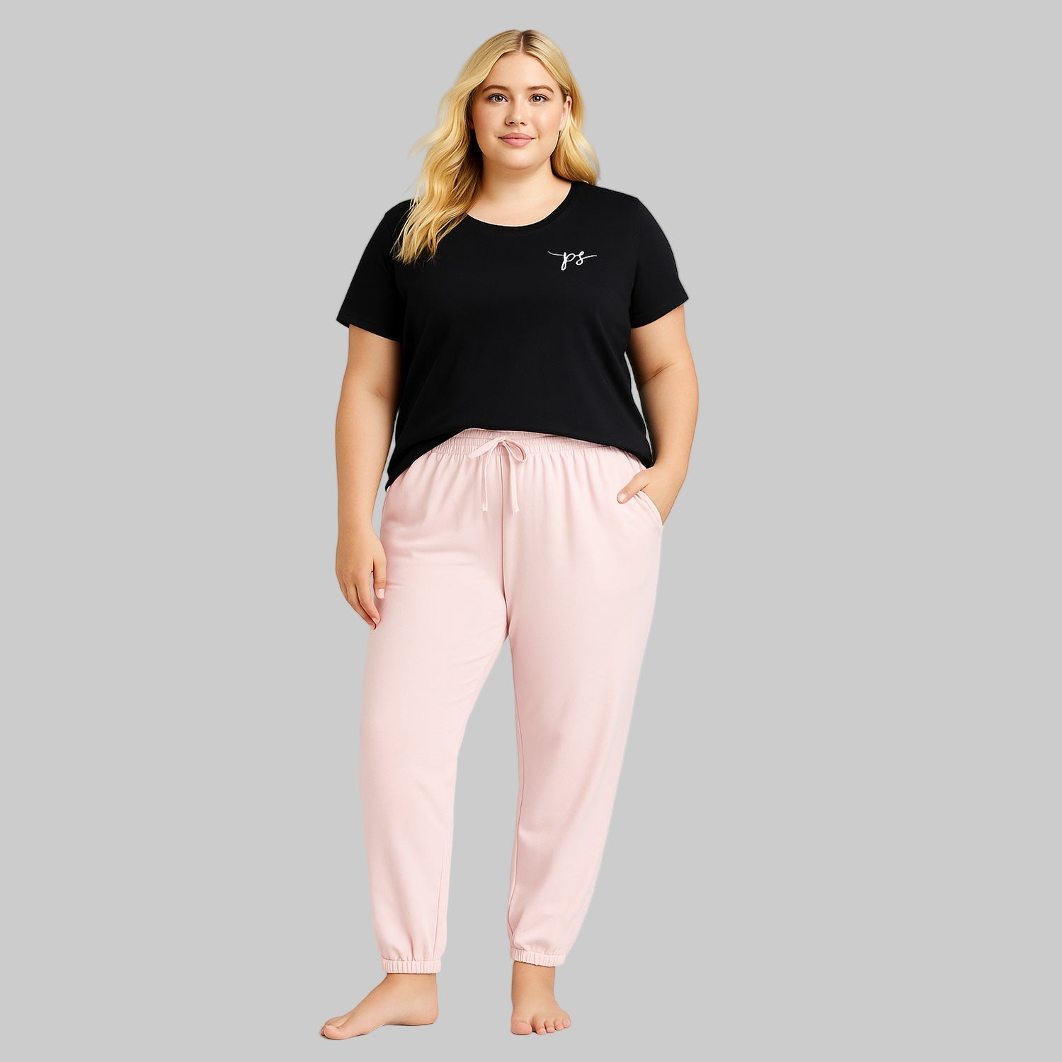Plus-size woman wearing Misty Rose fleece jogger sweatpants with drawstring waist and elastic cuffs, styled with side pockets.