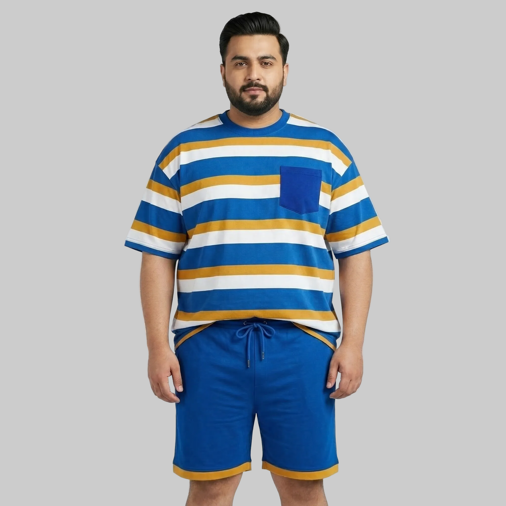 Man wearing a blue, yellow, and white striped shirt with blue shorts on a gray background