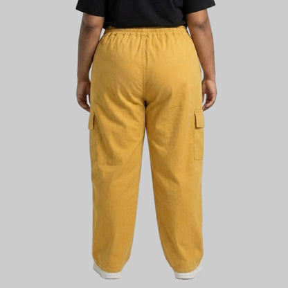 Mustard Gold Cargo Baggy Trousers made from premium 98% cotton, 2% elastane twill dyed fabric featuring a relaxed baggy fit, elastic waistband, and utility cargo pockets.