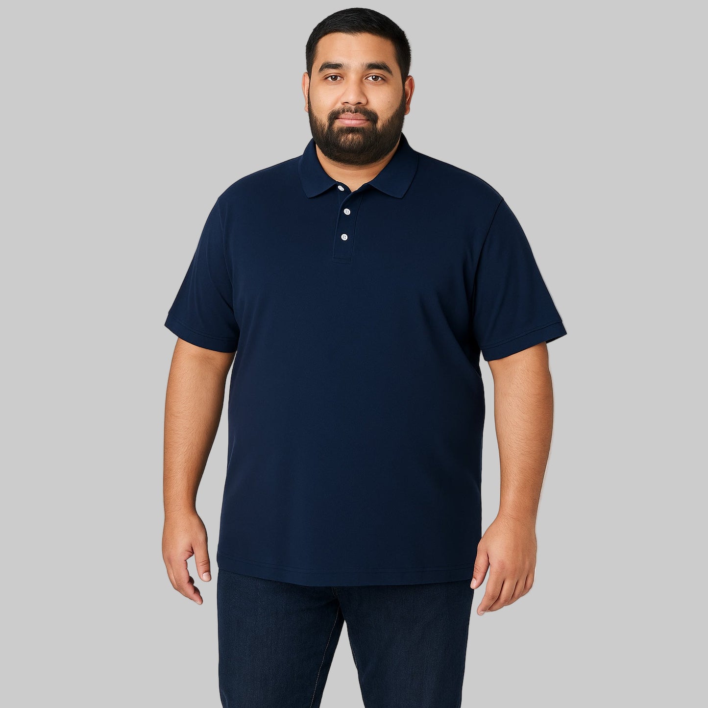 Plus-size Pakistani male model wearing navy blue piqué polo shirt with dark jeans on a light-gray background, front and back views, relaxed fit.
