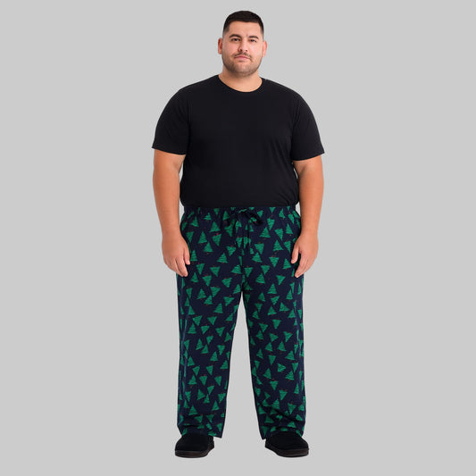 Plus-size man wearing navy evergreen flannel pajama pants with drawstring waist and side pockets.