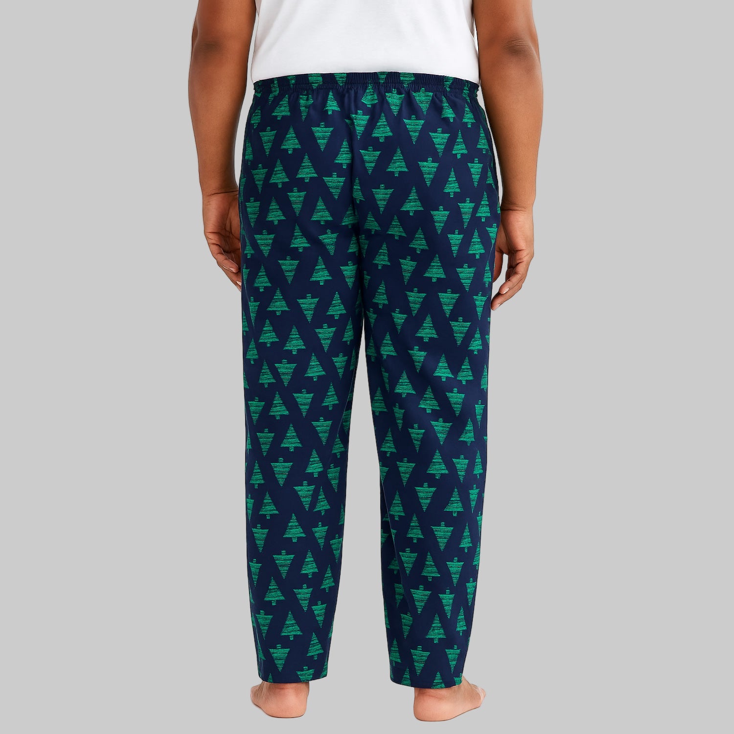 Plus-size man wearing navy evergreen flannel pajama pants with drawstring waist and side pockets.