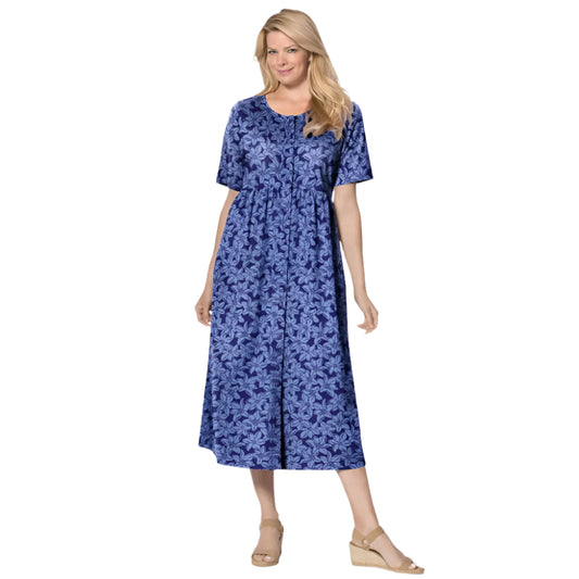 Woman wearing navy floral button-front dress with gathered waist and elbow sleeves