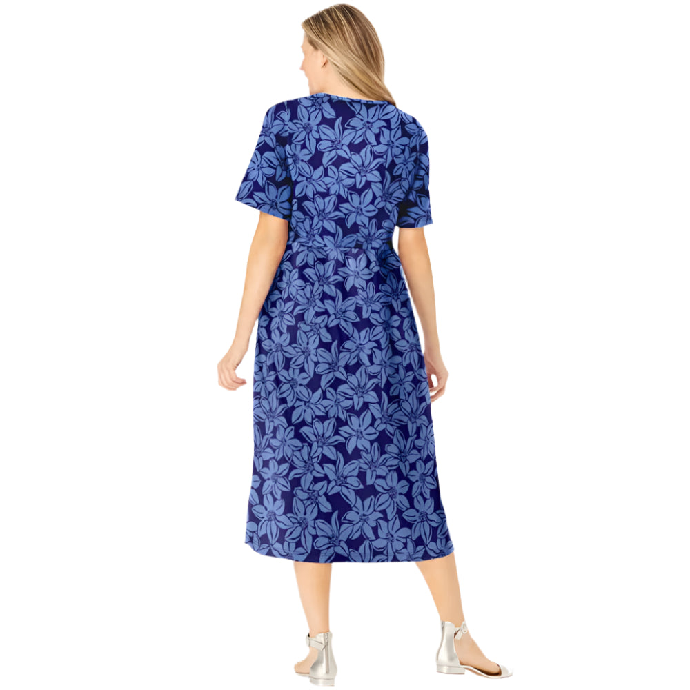 Woman wearing navy floral button-front dress with gathered waist and elbow sleeves
