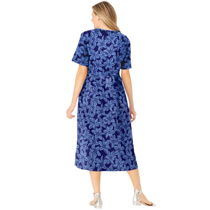 Woman wearing navy floral button-front dress with gathered waist and elbow sleeves