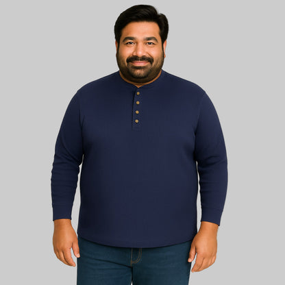 Model wearing navy waffle-knit thermal Henley tee with ribbed cuffs and five-button placket on a clean white background.
