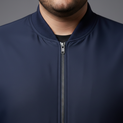 Navy blue plus size bomber jacket with front zip closure and ribbed cuffs on a clean background.