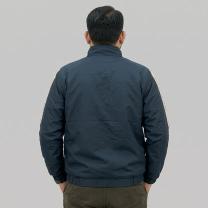  Navy blue polyester jacket with yellow and white side stripes printed with “BE ONE WITH WHAT YOU WEAR” text. 