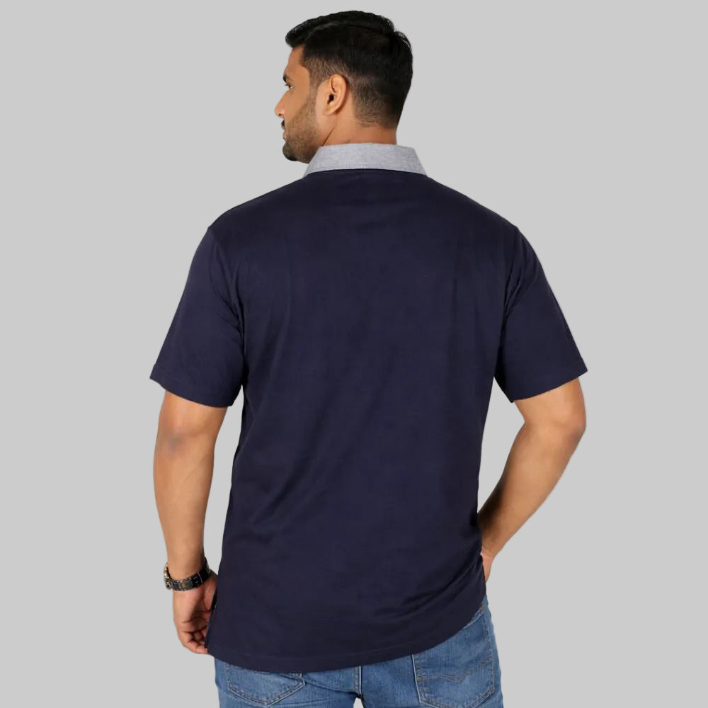 Plus size male model wearing navy polo shirt with grey contrast collar and trim front view