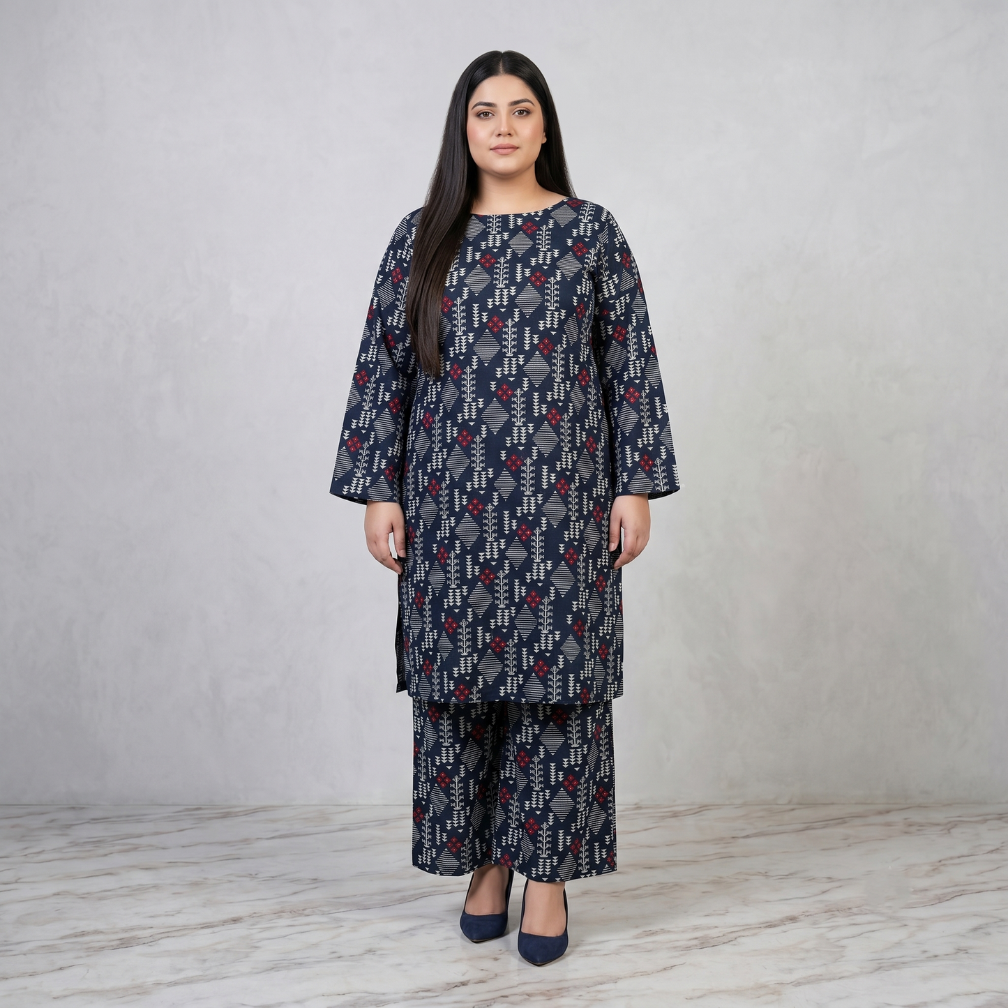 Woman wearing a patterned outfit on a plain background