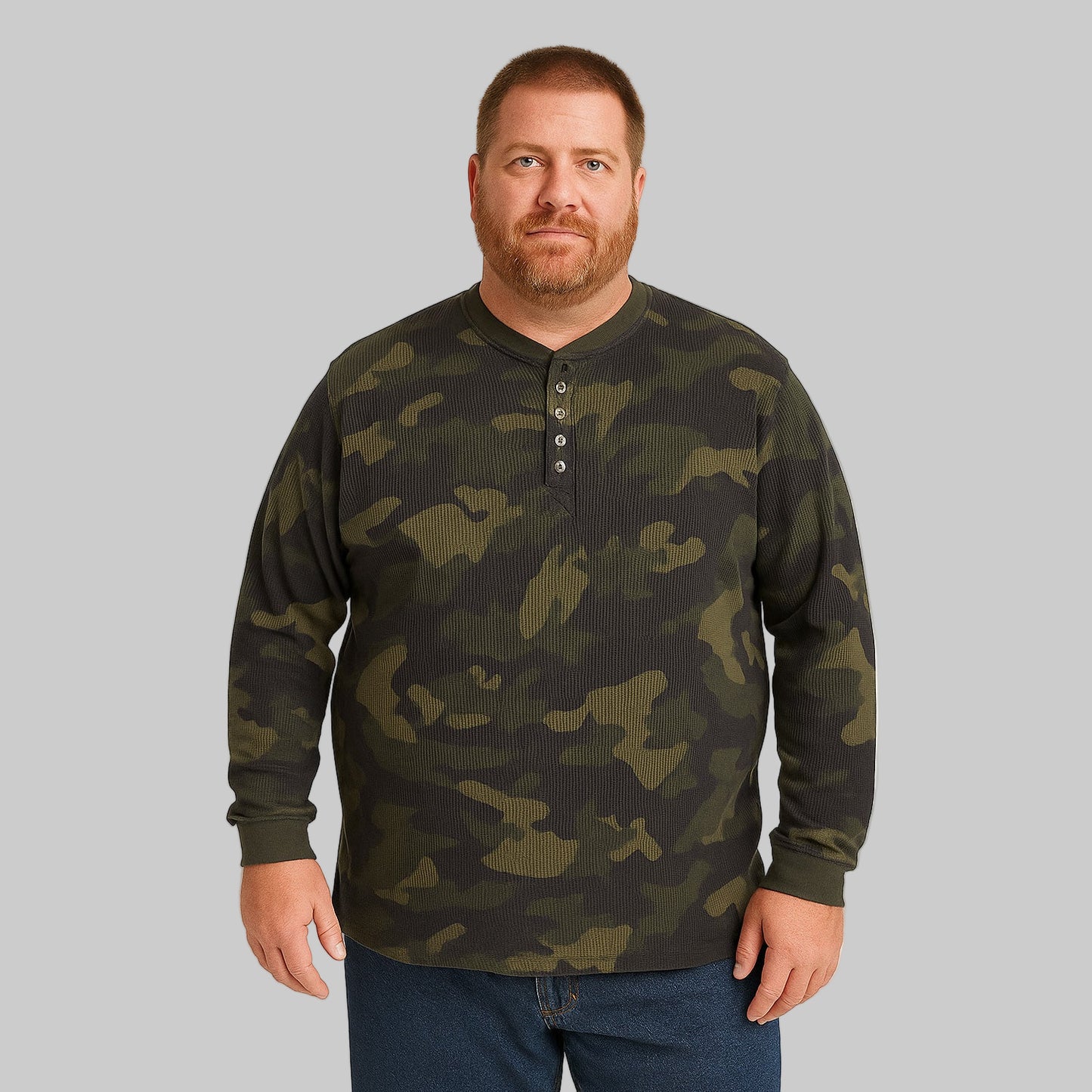 Plus-size Pakistani male model wearing olive camo waffle-knit thermal Henley tee, long sleeves, front view on studio background.