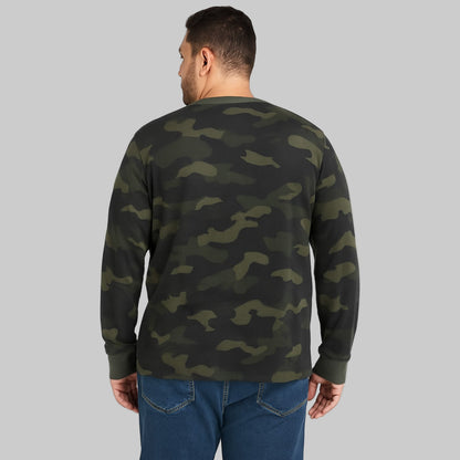Plus-size Pakistani male model wearing olive camo waffle-knit thermal Henley tee, long sleeves, front view on studio background.