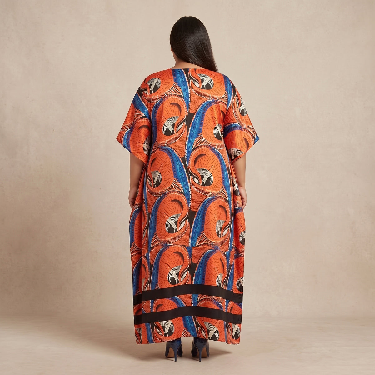 Orange and blue abstract swirl print maxi kaftan in lightweight polyester with a colorful pattern and flowing silhouette.