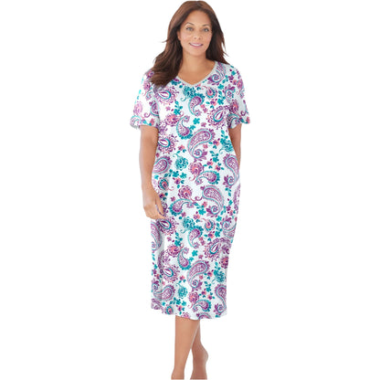 Woman in white sleepshirt with orchid paisley floral print and short sleeves