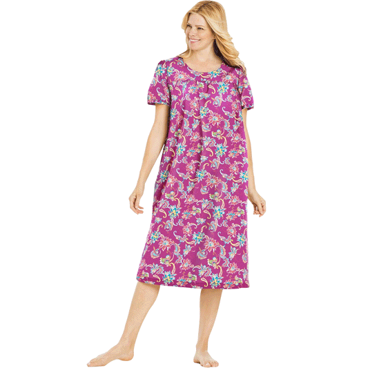 Plus-size woman wearing a short-sleeve lounger with a paradise pink paisley print, featuring shirred front and back yokes and side seam pockets.