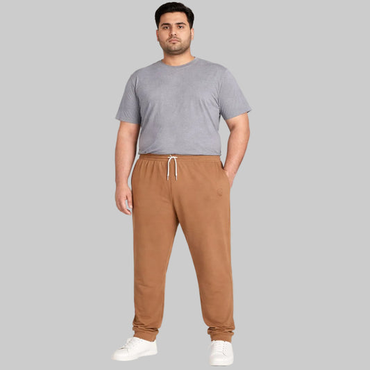 Peach brown plus-size terry joggers with a relaxed fit, soft loop-back fabric, elastic waistband, adjustable drawstring, and tapered legs, styled for everyday comfort and casual wear.