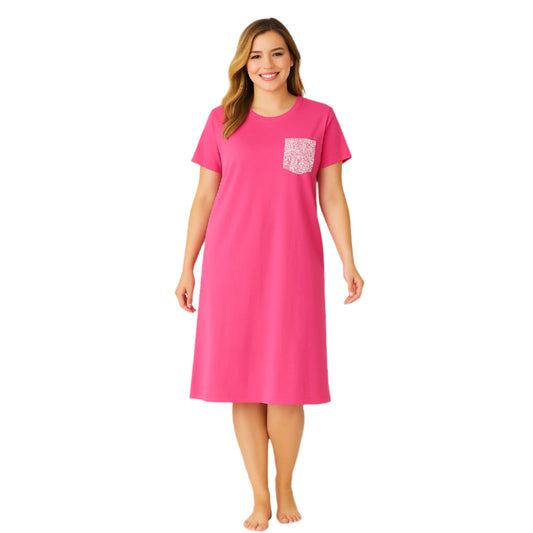 Plus-size woman wearing a pink lounge dress with short sleeves and a floral chest pocket

