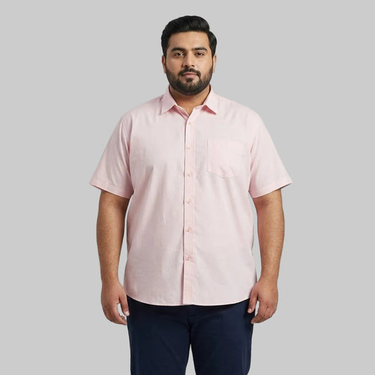 Men's pink casual short sleeve button-up shirt with a classic spread collar and front button closure laid flat on a white background.
