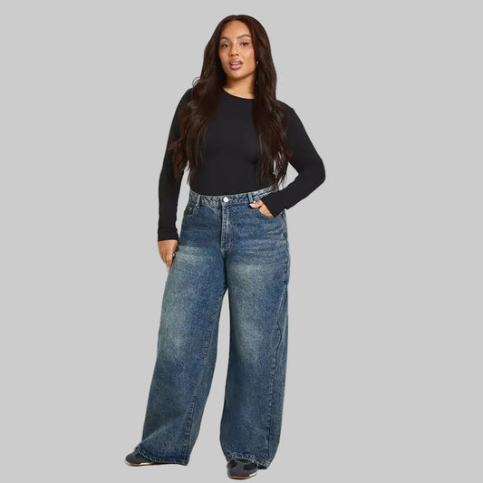 Plus size vintage wash wide leg blue denim jeans with high rise waist and relaxed fit