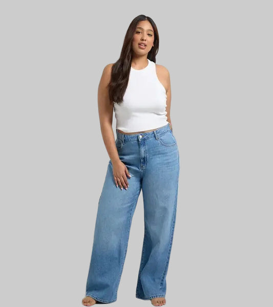 Plus size woman wearing wide leg mid blue denim jeans in a casual look
