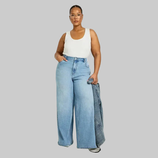 Plus size woman wearing wide leg mid blue denim jeans in a casual outfit