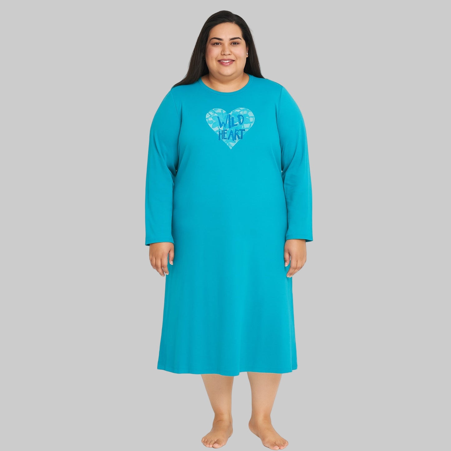 Plus-size woman wearing a Pool Blue Long Sleeve Sleepshirt, knee-length with long sleeves, made from soft cotton jersey, perfect for sleep and lounge.