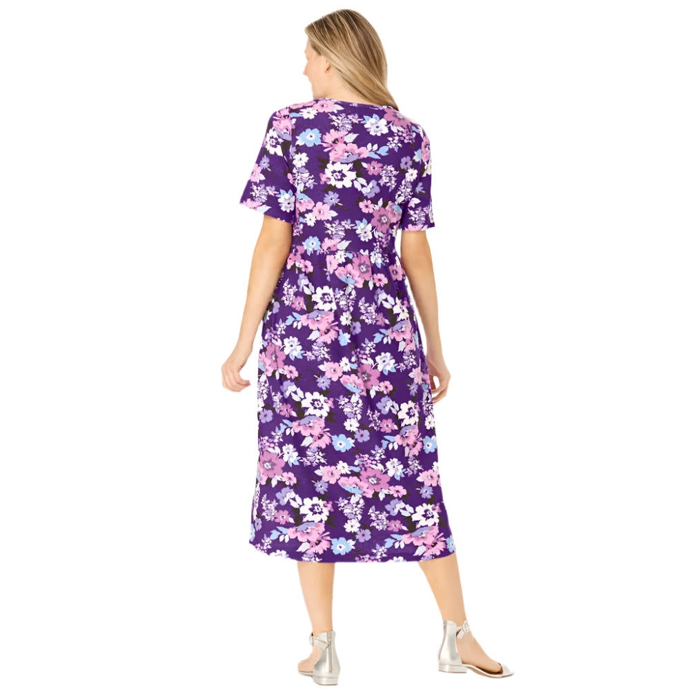 Woman wearing radiant purple garden print button-front dress with gathered waist and flowing skirt