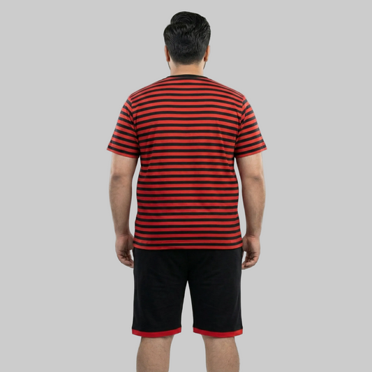Person wearing a red and black striped shirt and shorts on a plain background