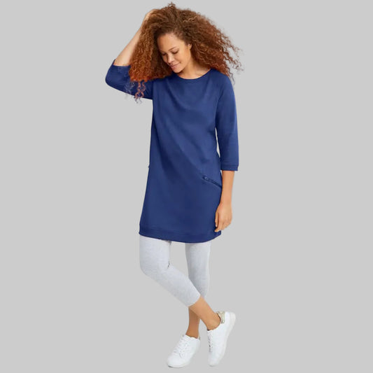 Royal cobalt French terry tunic with raglan sleeves, ribbed detailing, slanted zip pockets, and mid-thigh length shown on a plain background.
