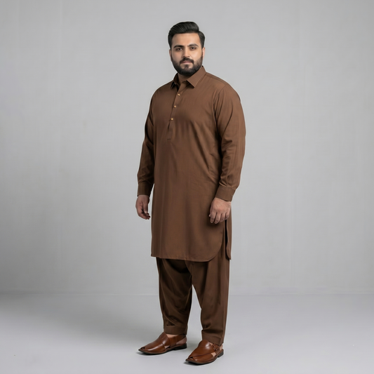 Man wearing a brown traditional outfit on a gray background