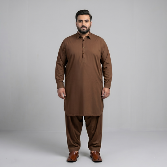 Man wearing a brown traditional outfit on a gray background