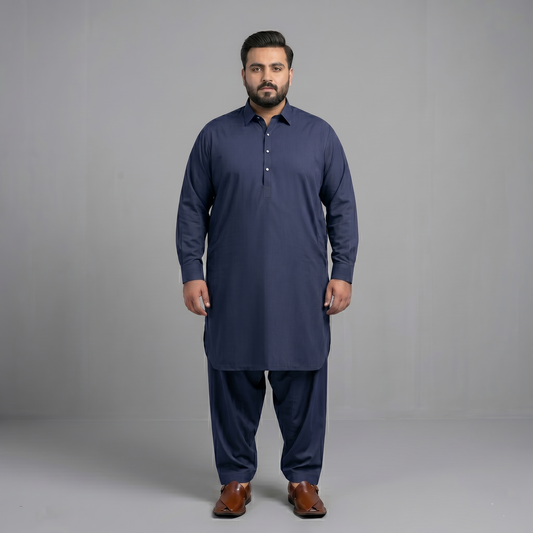 Man wearing a navy blue kurta with pants on a gray background