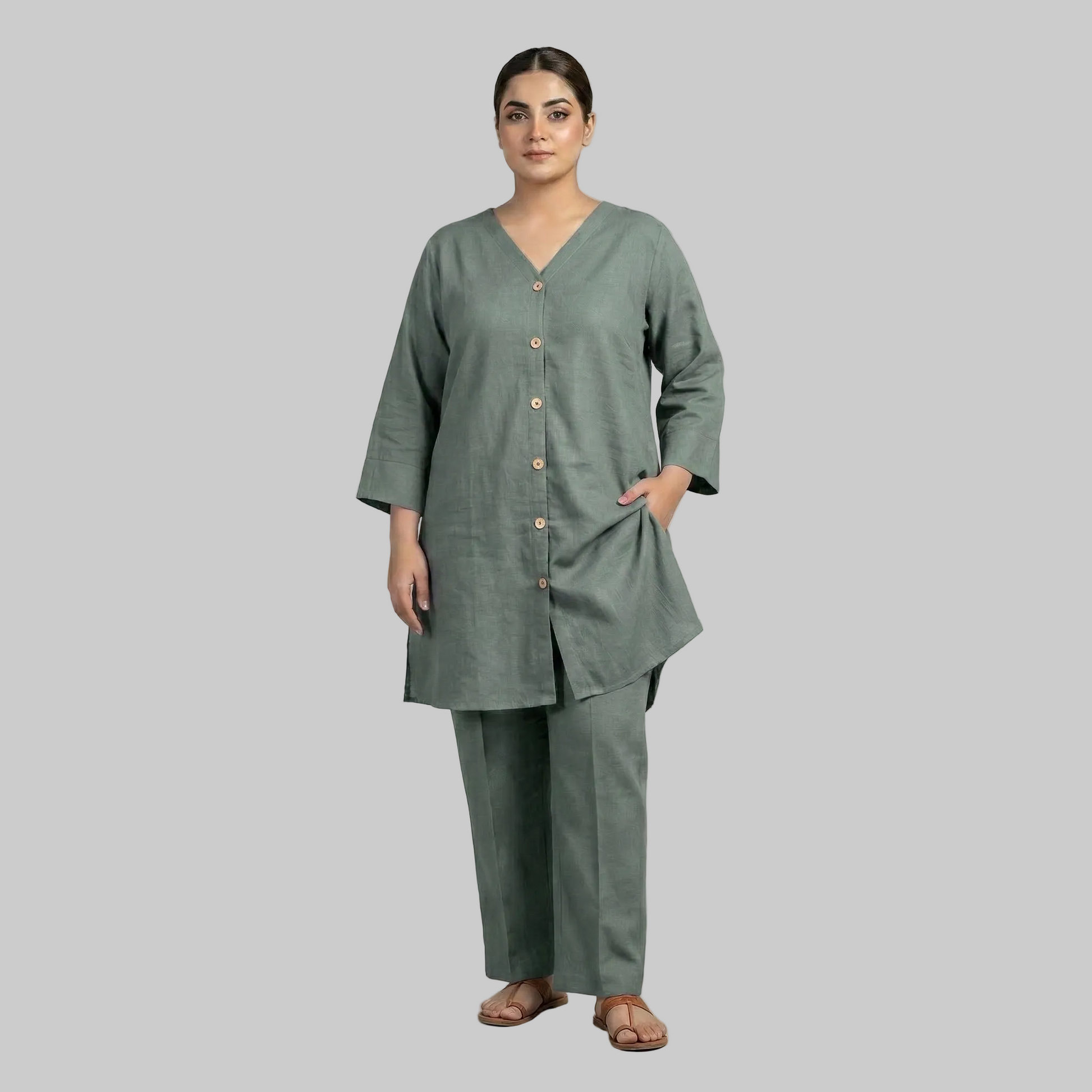 Woman wearing a green outfit with a plain background