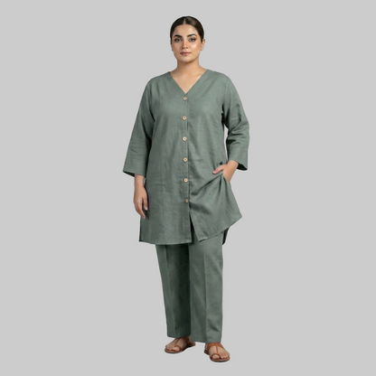 Woman wearing a green outfit with a plain background