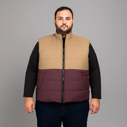 plus-size sleeveless puffer jacket with zip closure, high collar, and quilted design.