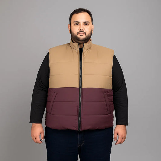 plus-size sleeveless puffer jacket with zip closure, high collar, and quilted design.