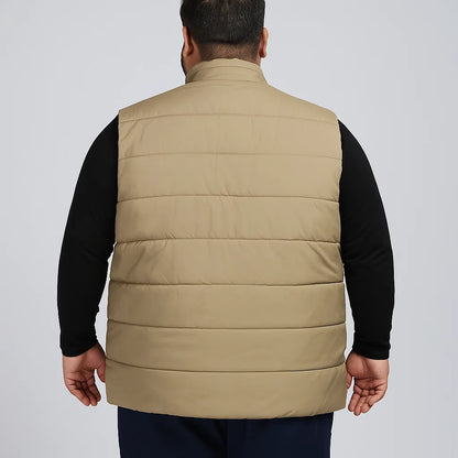 plus-size sleeveless puffer jacket with zip closure, high collar, and quilted design.