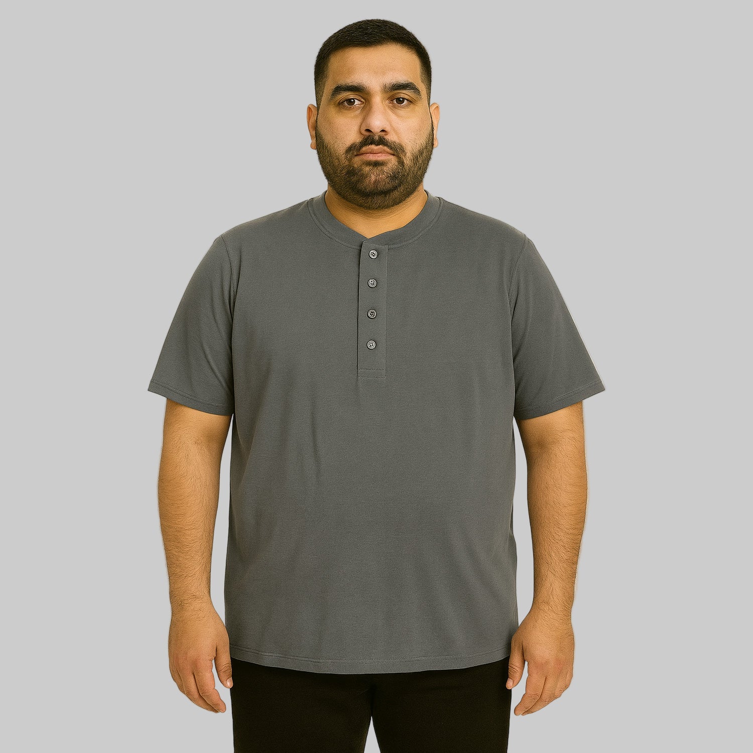 Plus-size Pakistani male model wearing steel short-sleeve Henley shirt on a clean studio background, relaxed fit.
